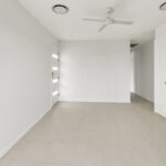 Bright, empty entry hall with a white door on the left, ceiling fan, and white built-in cabinets on the right.
